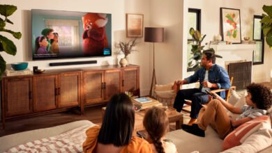 Family watches 'Turning Red' on a large TV in a cozy living room.