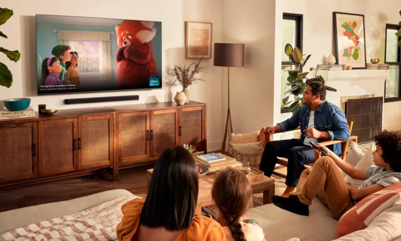 Family watches 'Turning Red' on a large TV in a cozy living room.