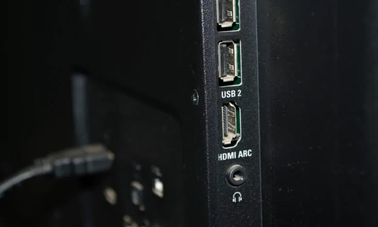 Close-up of the back of a TV with USB and HDMI ports.