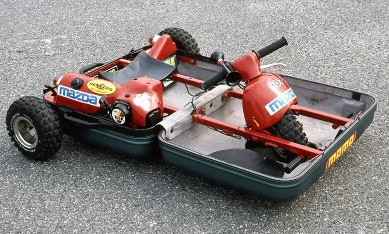 Unique go-kart built inside two suitcases, red frame, Mazda logos.