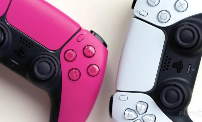 Close-up of a pink and white Playstation 5 DualSense controllers.