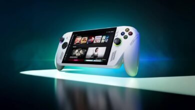 White ROG Ally handheld gaming console on a spotlighted surface.