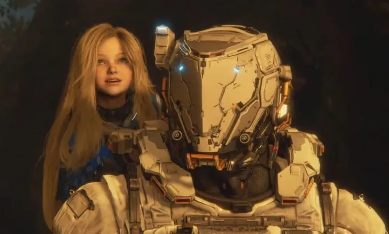 Girl with long blonde hair stands next to a futuristic armored figure.