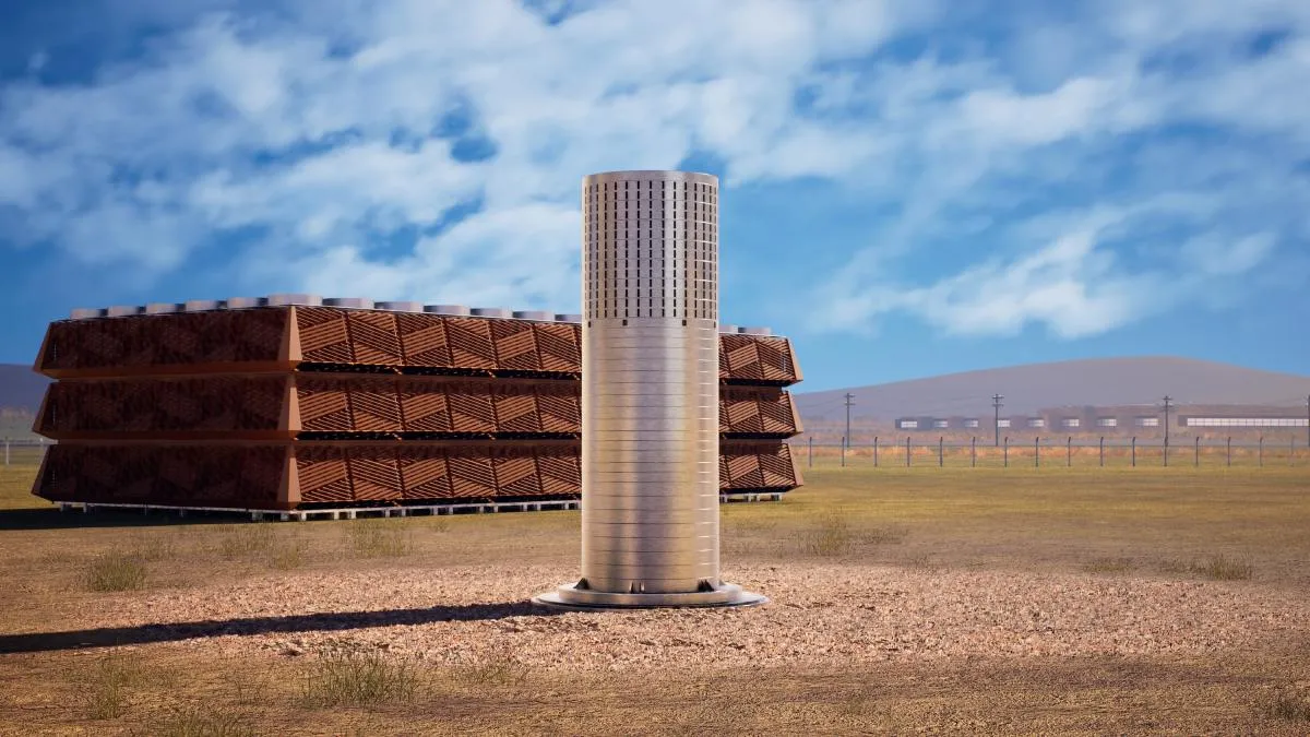 Rendering of a cylindrical reactor with cooling towers in a field under a blue sky.