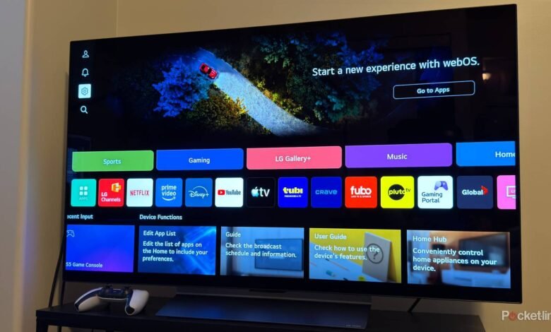 LG OLED TV displaying webOS interface with app icons and a scenic background.