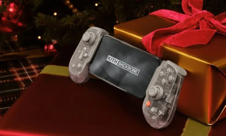 Kith Backbone game controller with gifts under Christmas tree.