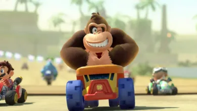 Donkey Kong in a kart racing, smiling with other racers nearby.