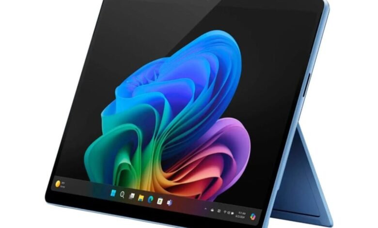 Blue tablet with colorful abstract wallpaper and kickstand on a white background.