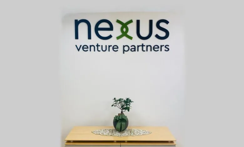 Nexus Venture Partners logo on wall with bonsai tree.