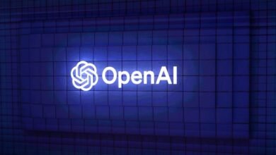 The OpenAI logo glows against a textured blue wall.