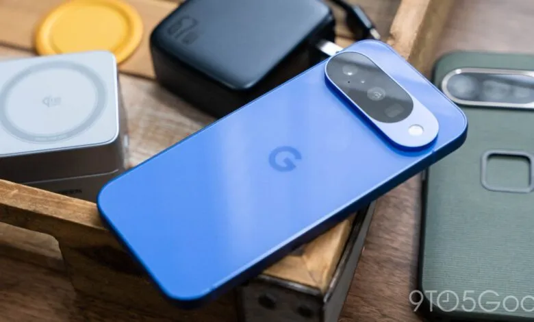 Blue Google Pixel phone with charger and accessories on wooden surface.