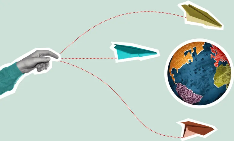 Hand launching paper airplanes toward a globe, symbolizing global reach.