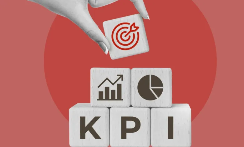 Wooden blocks spelling KPI with target icon being placed on top.