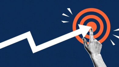 White arrow points to orange target, hand touches bullseye.