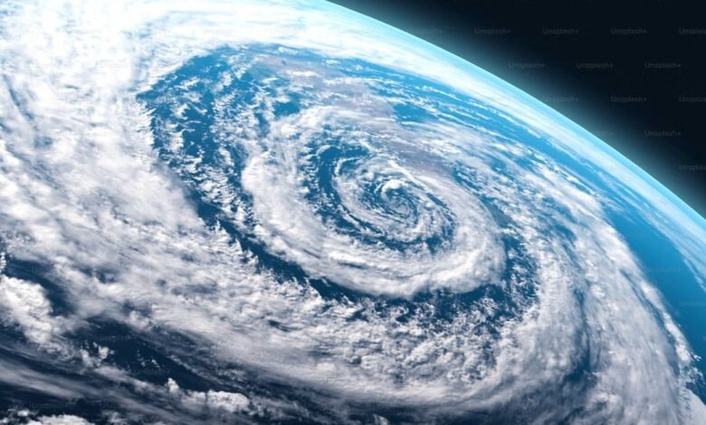 Satellite view of Earth showing a large hurricane with swirling clouds.