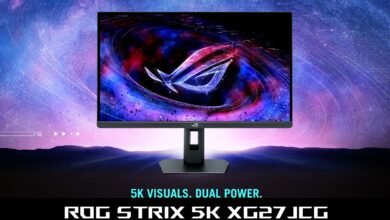 ROG Strix 5K XG27JCG monitor displaying a nebula-like image with the ROG logo.