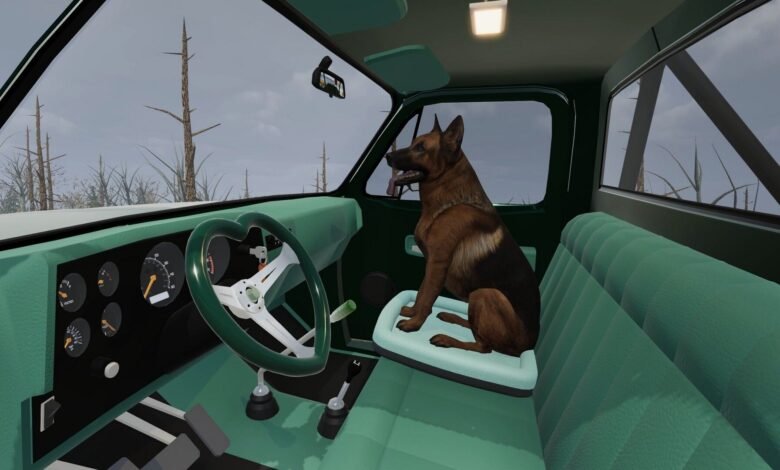 German Shepherd sits on a dog bed in the driver's seat of a green pickup truck.