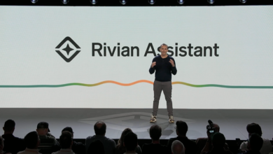 Presenter on stage at Rivian Assistant event, audience in foreground.