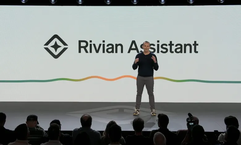 Presenter on stage at Rivian Assistant event, audience in foreground.