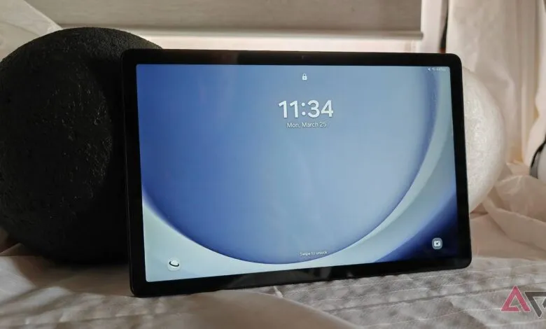 Samsung Galaxy Tab A9+ displaying the time 11:34 on a blue background.
