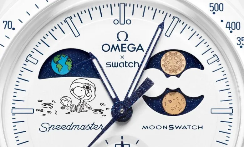 Close-up of Omega x Swatch MoonSwatch watch face with Snoopy and Earth/Moon phases.