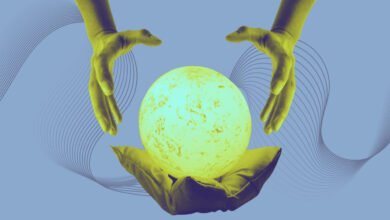 Two hands hover over a glowing orb resting on a cushion against a blue background.
