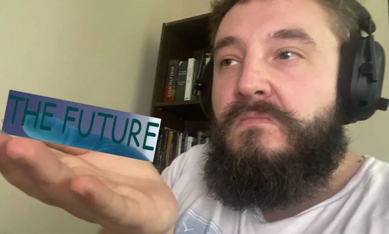 Man with beard and headphones holds 'The Future' graphic in his palm.