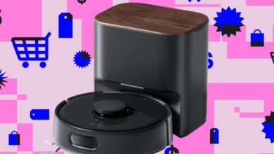 SwitchBot robot vacuum and dock on a pink and white patterned background.