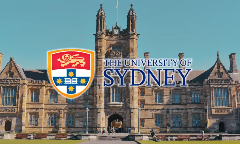 University of Sydney's sandstone building with its crest against a clear blue sky.