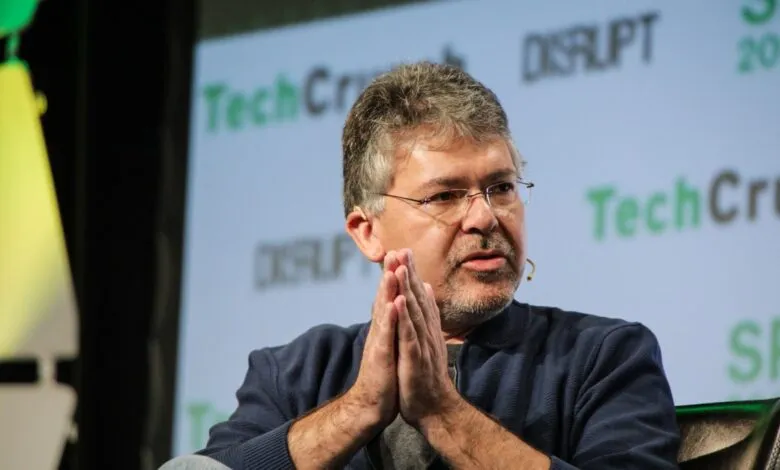 John Giannandrea at TechCrunch Disrupt, hands clasped, speaking.