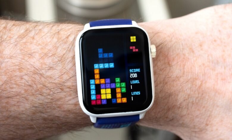 Smartwatch displaying Tetris game on a hairy wrist.