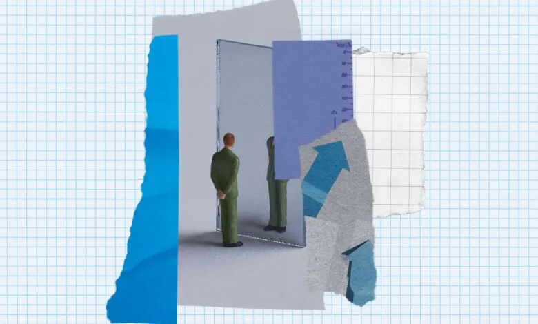 Miniature figure in suit faces mirror amid paper scraps on graph paper.