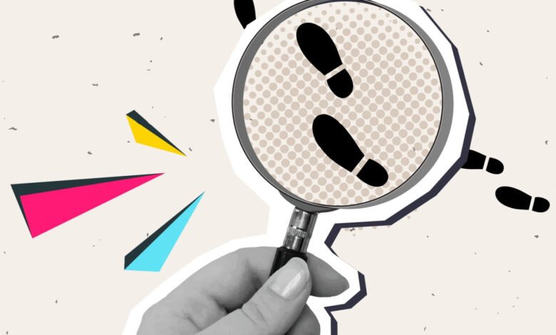Magnifying glass over footprints, symbolizing user journey tracking.