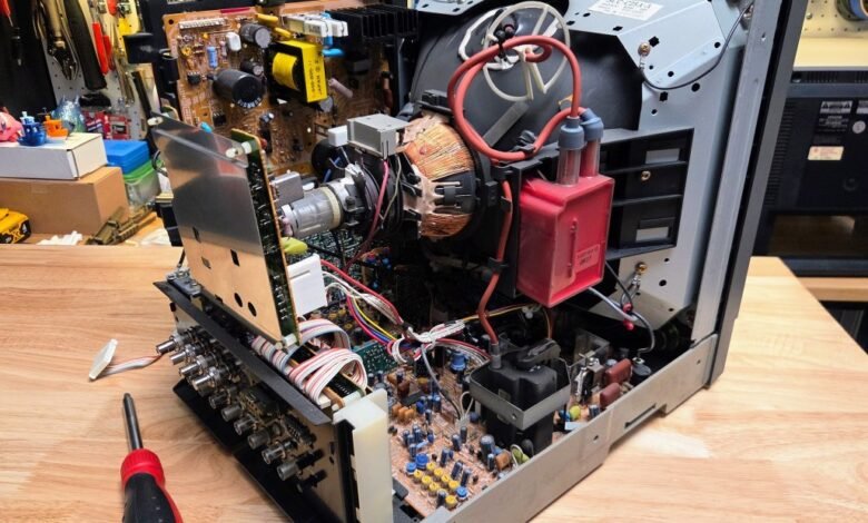 Open CRT television showing internal components for repair or maintenance.