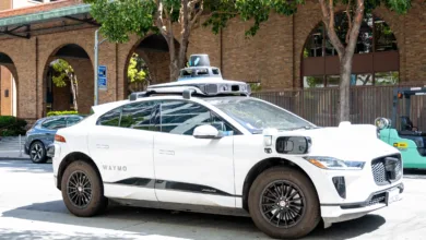 White Waymo Jaguar I-Pace self-driving car parked on a city street.