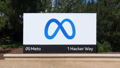 Meta headquarters sign with blue infinity logo and '1 Hacker Way' address.
