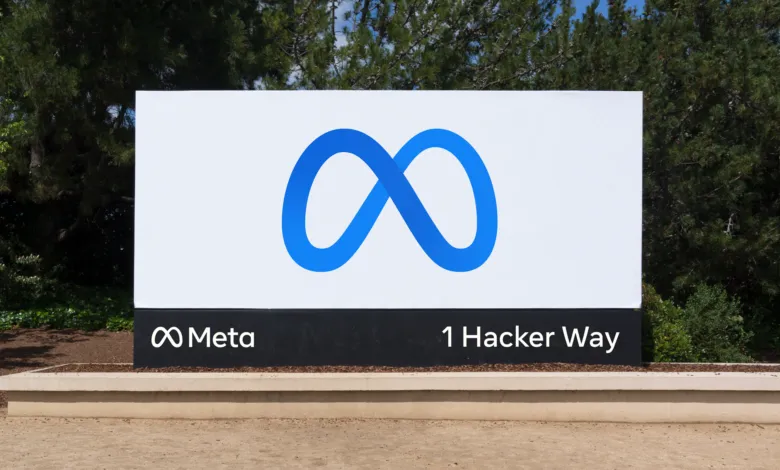 Meta headquarters sign with blue infinity logo and '1 Hacker Way' address.