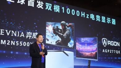 Presenter showcasing new gaming monitors with high refresh rates.