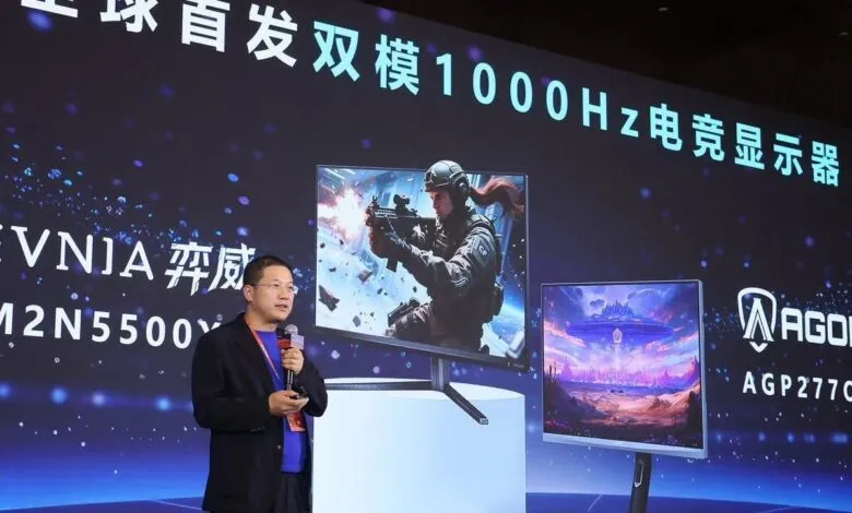 Presenter showcasing new gaming monitors with high refresh rates.