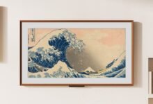 Framed print of 'The Great Wave off Kanagawa' hangs on a white wall.