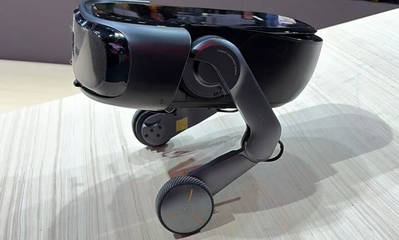 Roborock robot dog with wheels on light wood surface.