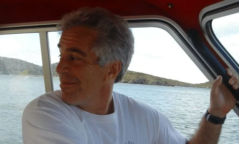 Jeffrey Epstein on a boat, looking out at the ocean and islands.
