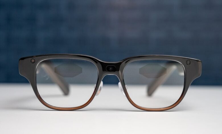 Close-up of smart glasses with a camera on the bridge and temples.