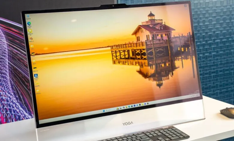 Lenovo Yoga AIO desktop computer with scenic lighthouse wallpaper.