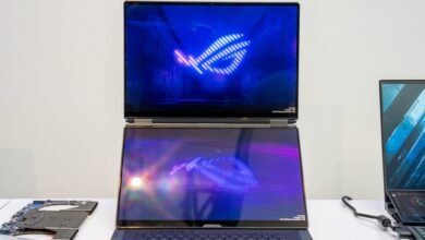 Asus ROG Zephyrus Duo laptop with dual screens displaying ROG logo.