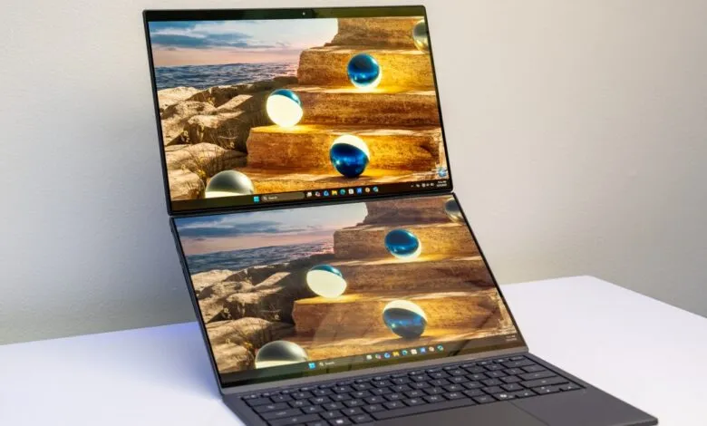 Asus Zenbook Duo laptop with dual screens displaying a beach scene with stairs and spheres.