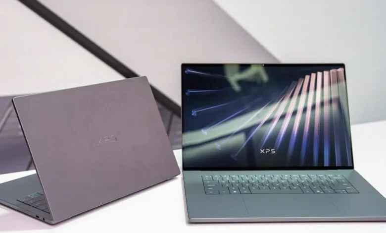 Two Dell XPS laptops, one open showing the screen, the other closed.
