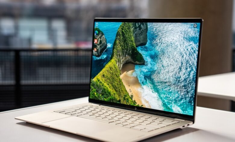 Sleek HP laptop displays a vibrant coastal landscape on its screen.