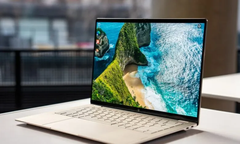Sleek HP laptop displays a vibrant coastal landscape on its screen.