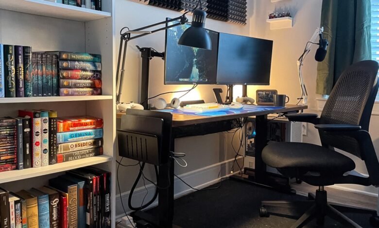 Home office setup with dual monitors, bookshelf, and ergonomic chair.